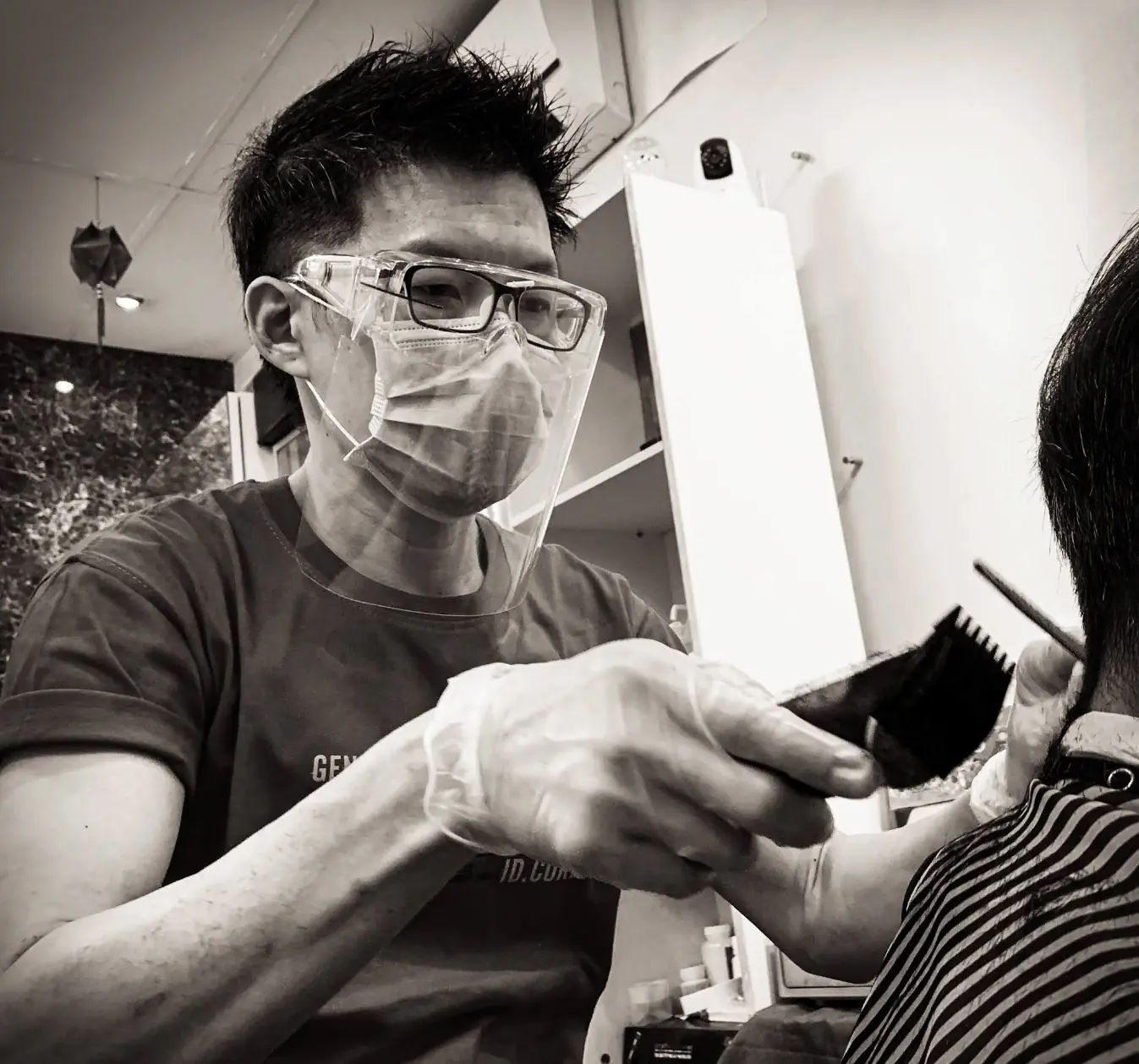 Barber Sam cutting customer's hair at Z Hair Studio Singapore